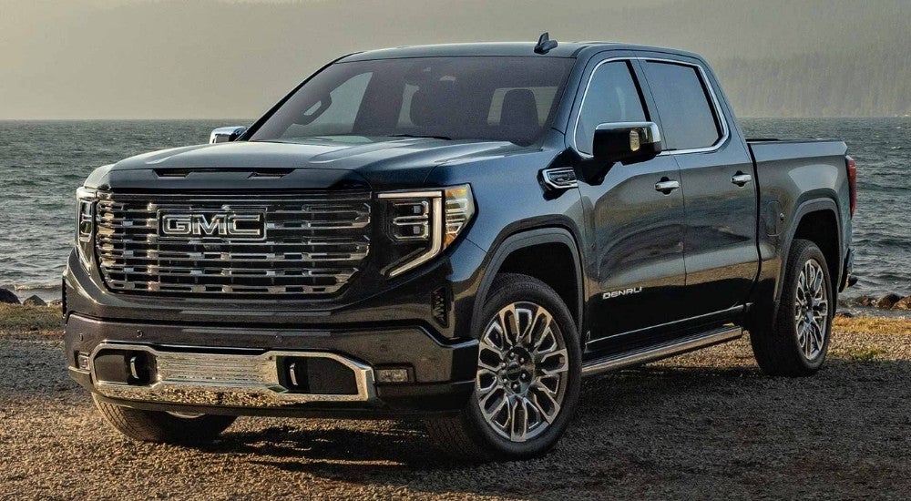 Black 2025 GMC Sierra 1500 Denali Ultimate parked near a lake