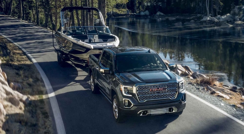 A black 2021 GMC Sierra 1500 towing a boat