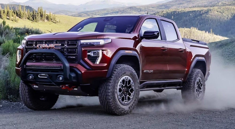Red 2023 GMC Canyon AT4X driving off-road
