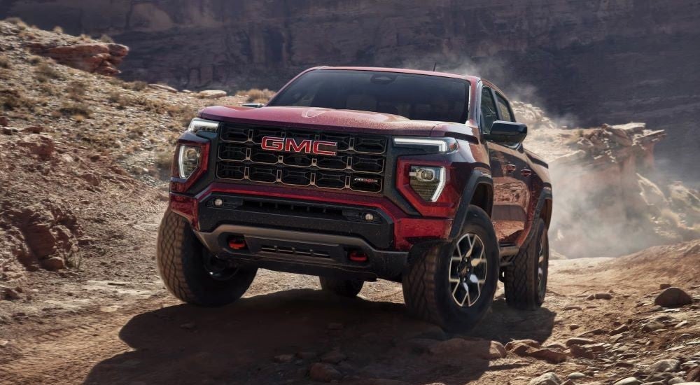 Red 2025 GMC Canyon AT4X driving on a trail