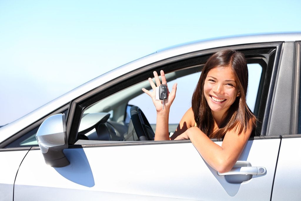 car driver woman smiling showing new car keys and car.
