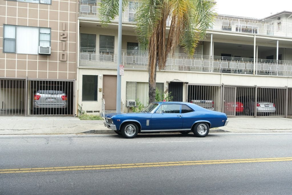 Car in front of apartments