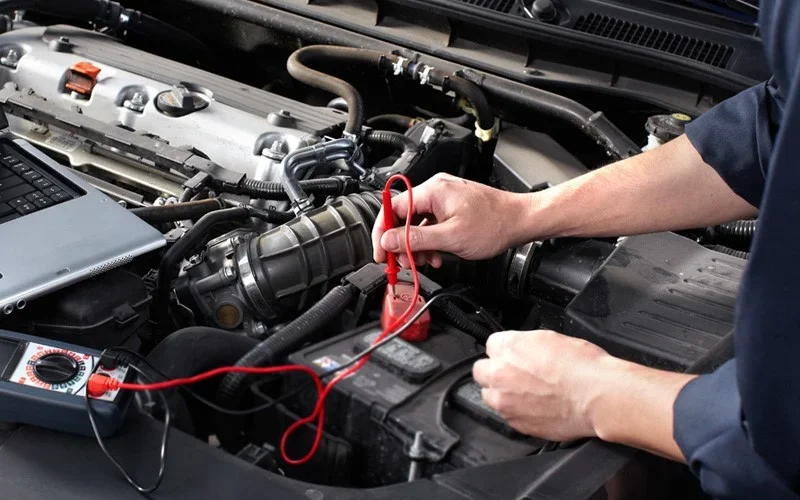 Mechanic checking car battery