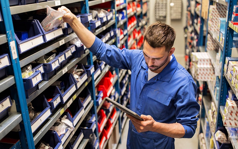 Certified GMC maintenance service person checking inventory at GMC