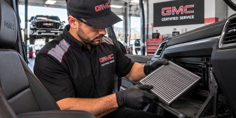 Technician inspecting a GMC cabin air filter