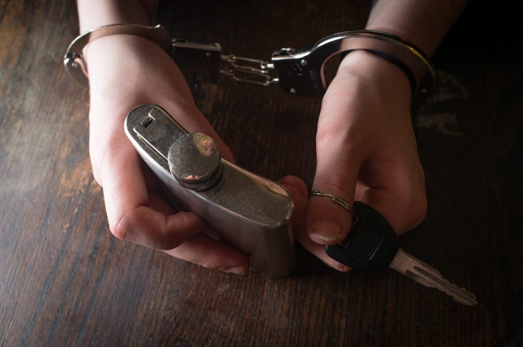 Man in handcuffs representing legal consequences for unpaid child support.