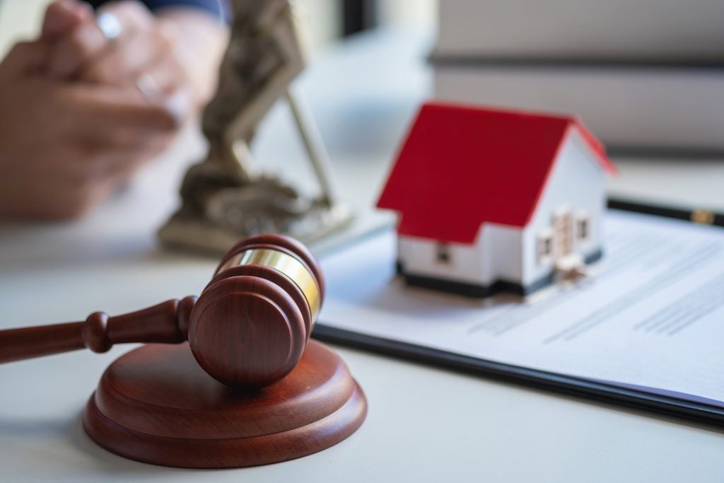 Gavel and scales of justice on a table representing updates to an estate plan during divorce.