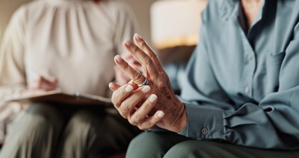 Man removing wedding ring symbolizing alimony modification under family law.