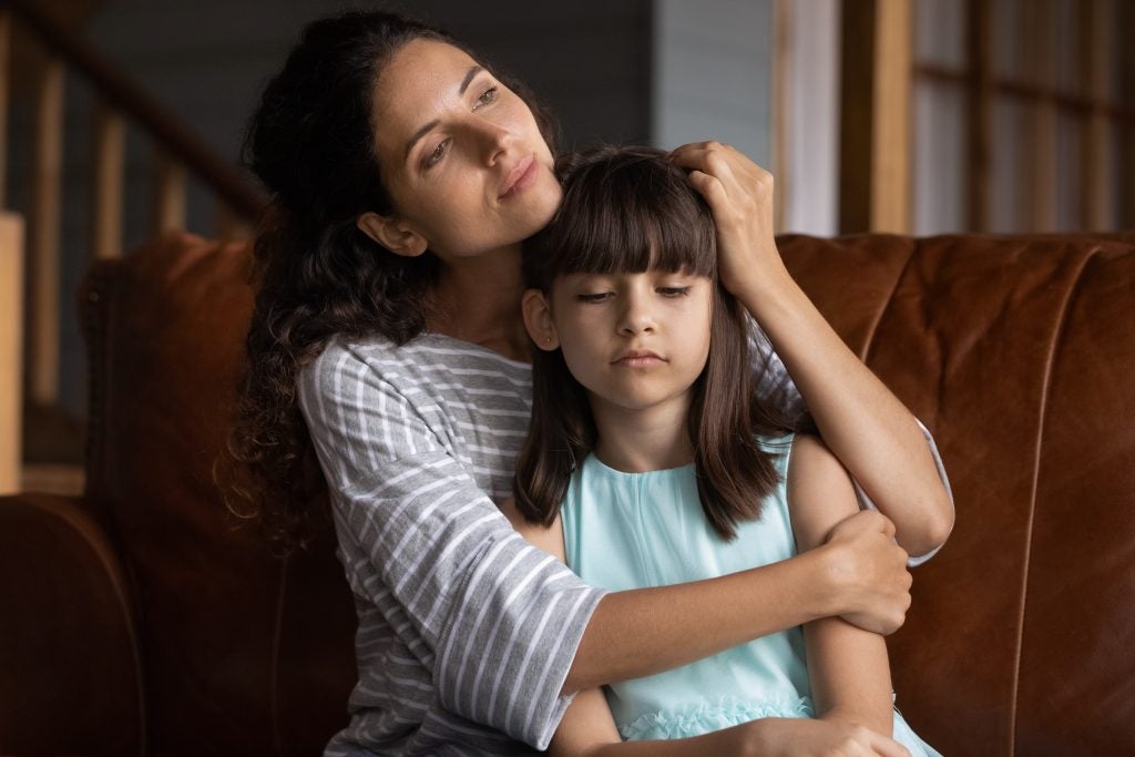 Mother holding child navigating custody and support.