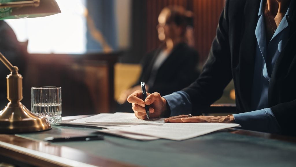 Man signing a legal will document.