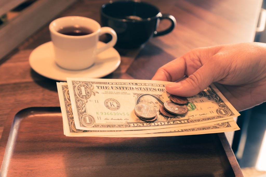 Person holding money in hand.