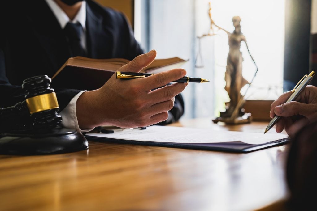 Lawyer discussing documents with a client.