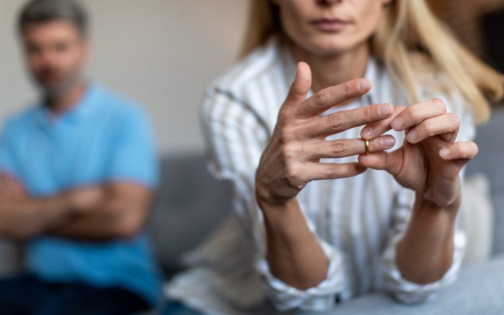 Woman removing wedding ring.