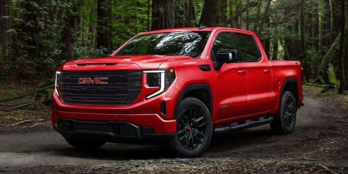 Red GMC Sierra 1500 parked in the dirt