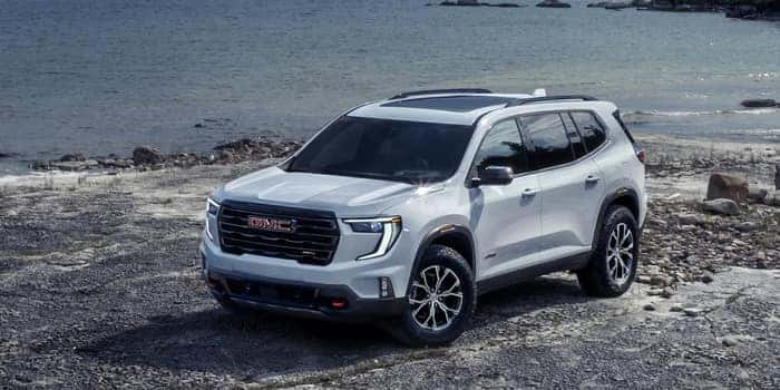 Silver GMC Acadia parked on rocks