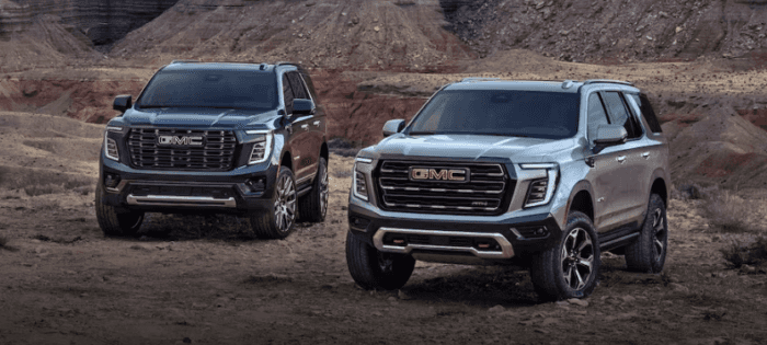 Two 2025 GMC Yukons parked in rocks