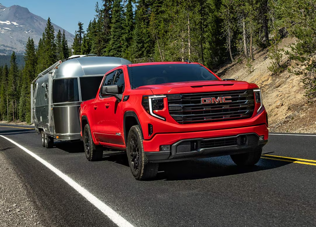 Red 2026 GMC Sierra 1500 towing trailer