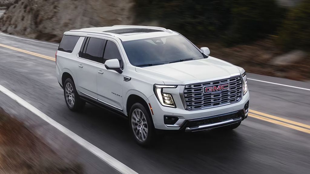 White 2026 GMC Yukon driving on road