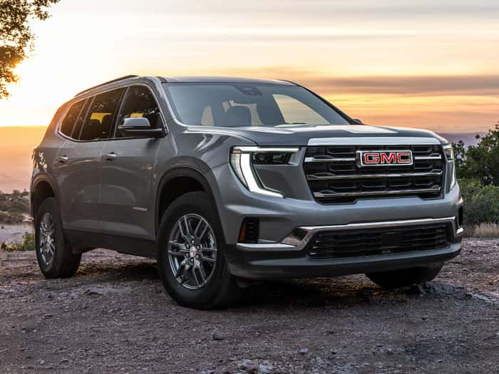 Gray GMC Acadia parked on the rocks