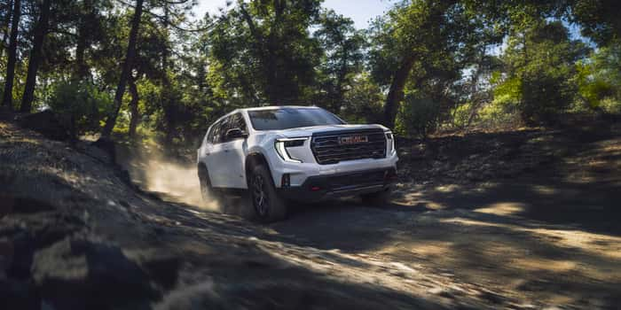 GMC Acadia driving on dirt trail