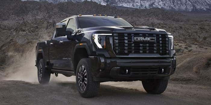 GMC Sierra HD driving on dirt road