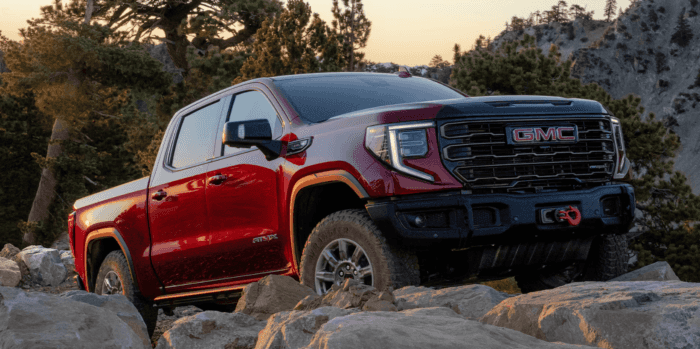 2026 GMC Sierra 1500 AT4X driving over rocks