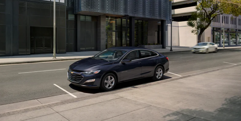 A black 2023 Chevrolet Malibu parked on a street.