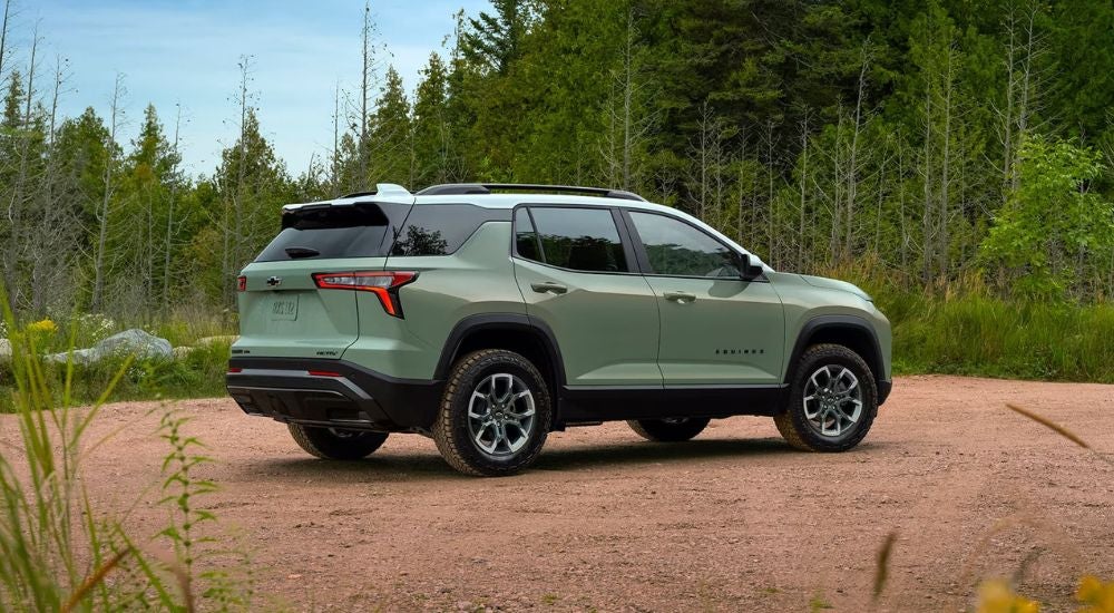 A rear view of a green 2025 Chevy Equinox.
