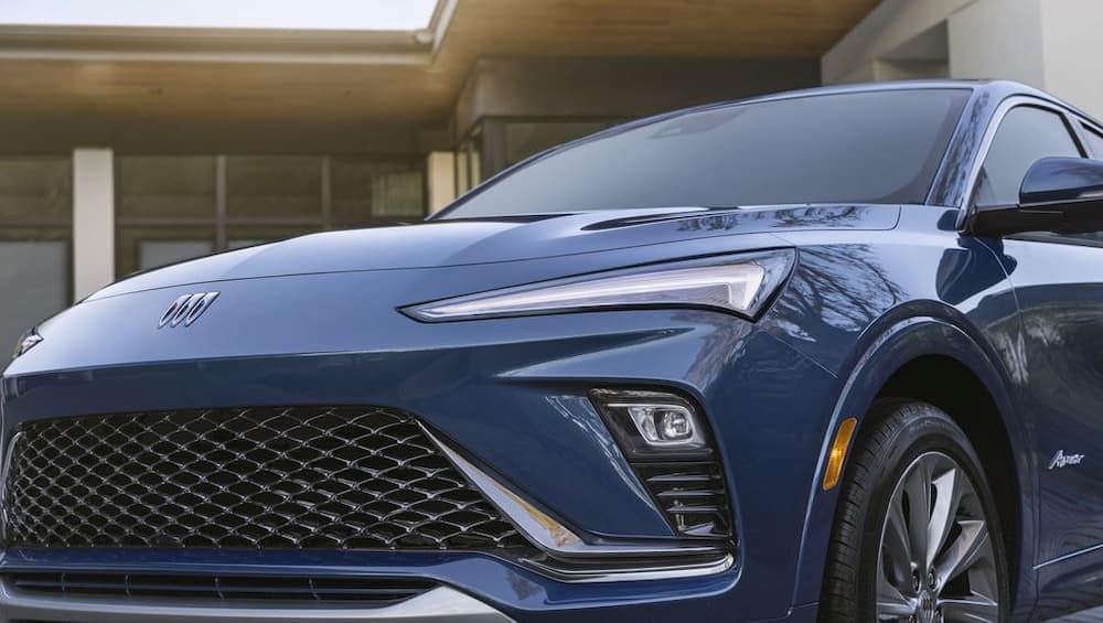 A close-up of the front end of a blue 2024 Buick Envista Avenir is shown.
