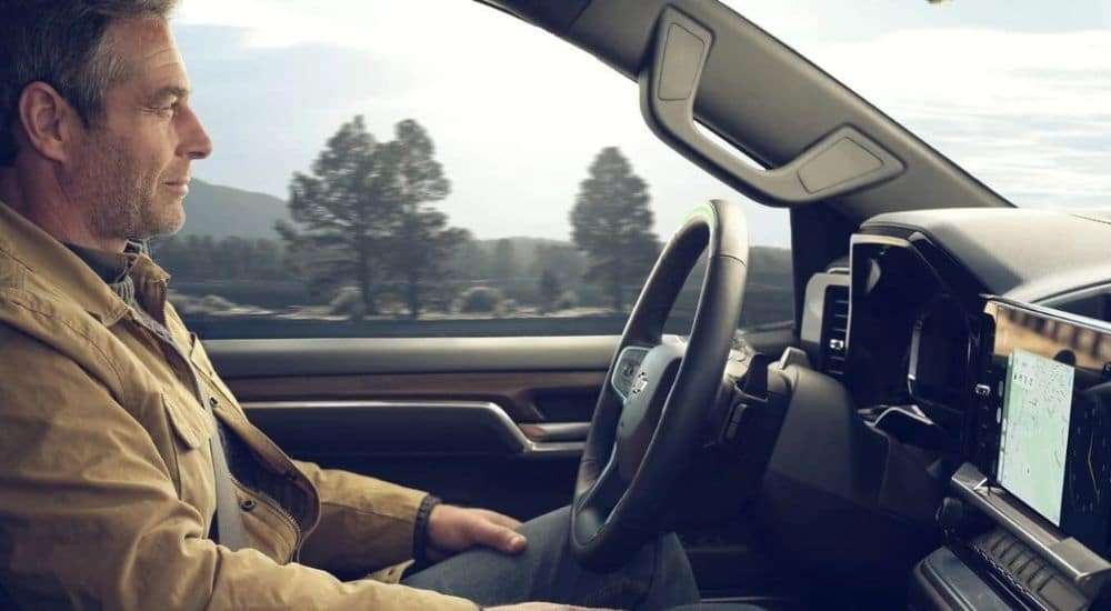 A person is shown utilizing SuperCruise in a 2024 Chevy Silverado 1500.