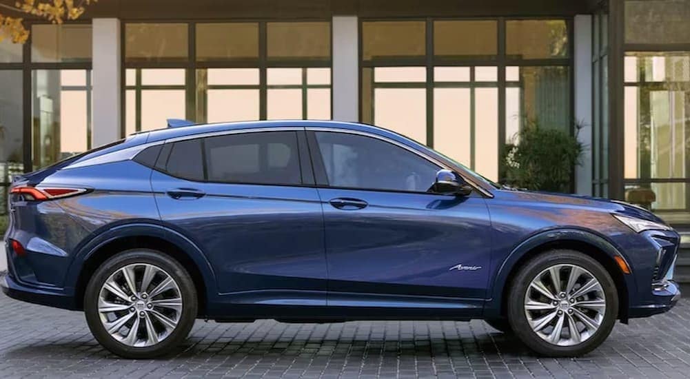 A blue 2024 Buick Envista Avenir is shown parked near a Buick dealer near Gowrie.
