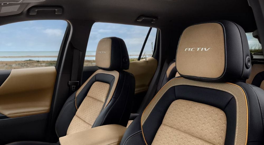 The brown and black front seats of a 2025 Chevy Equinox ACTIV.