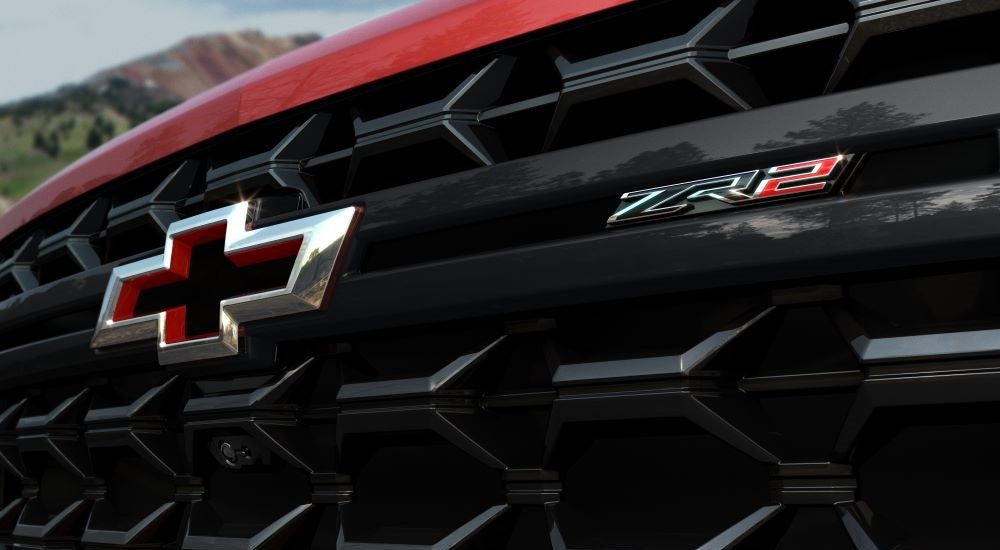 A close-up on the grille of a red 2024 Chevy Silverado 2500HD ZR2.
