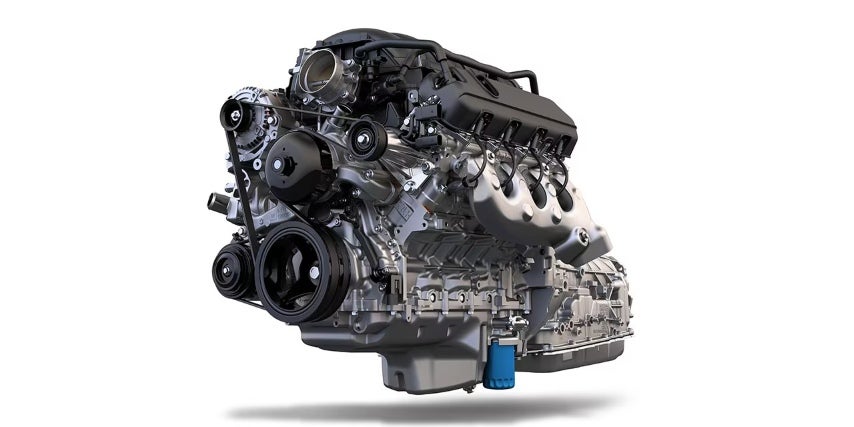 Isolated view of a high-performance V8 engine block with visible belts, pulleys, and components on a white background.