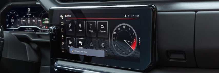 Close-up of GMC Sierra digital infotainment display showing icons for navigation, music, phone, and clock.