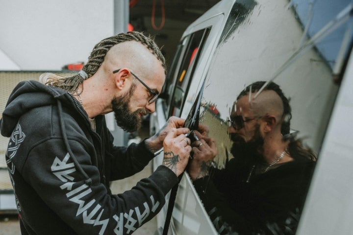 Technician tinting car windows.