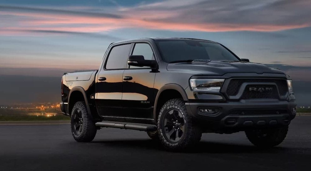 Black 2025 Ram 1500 parked on a parking lot near a Ram dealer near Ogallala.