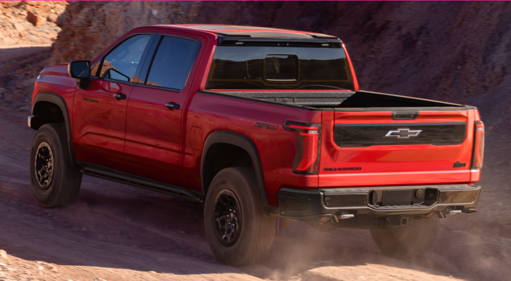 Red 2027 Chevy Silverado 1500 from the rear on a dusty trail
