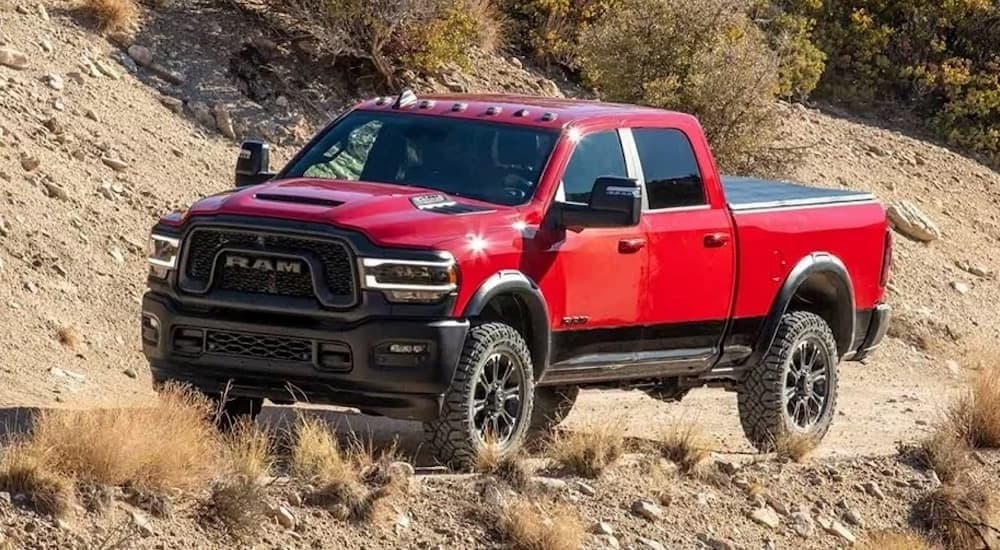 A red 2025 Ram 2500 from the front at an angle after leaving a dealer that has work trucks for sale.