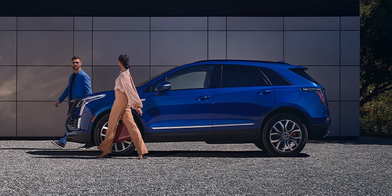 people passing by Cadillac XT5.