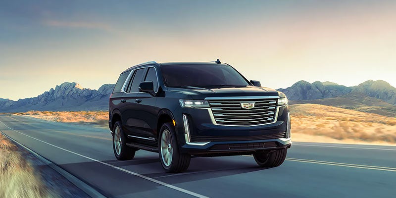 2023 Cadillac Escalade driving on road.