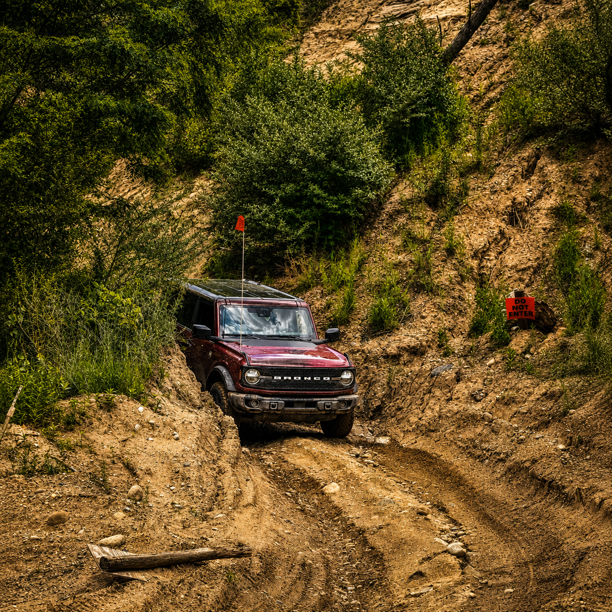 Red Bronco in narrow off-road trench
