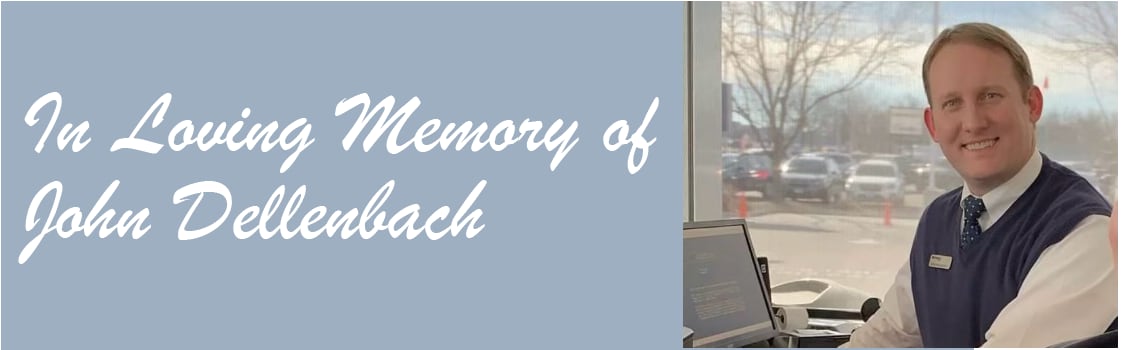 John Dellenbach smiling in a showroom with "In Loving Memory of John Dellenbach" on a light blue background.