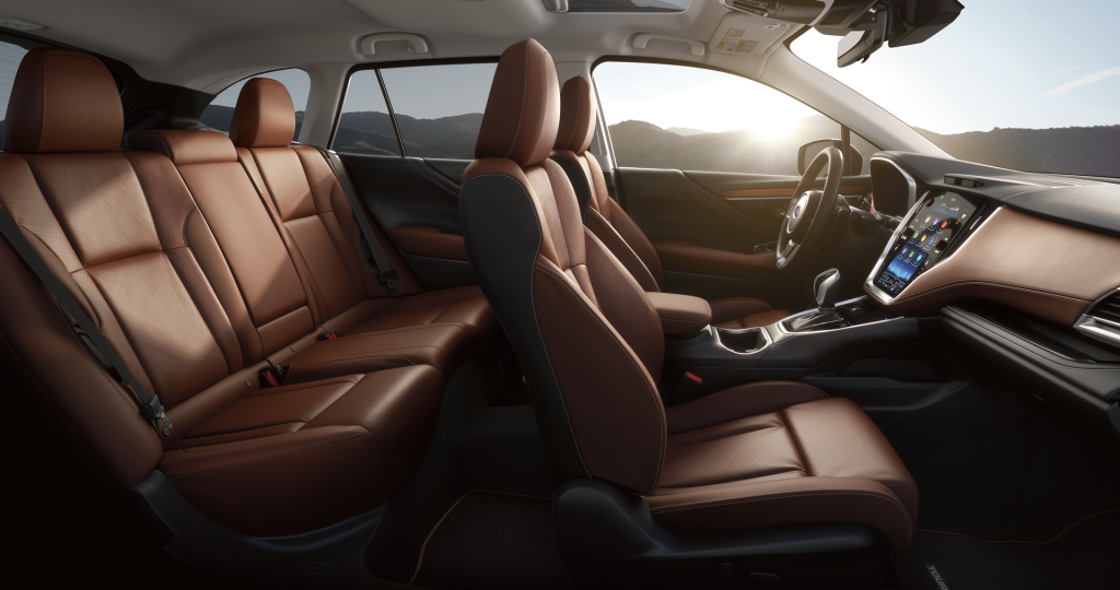 Interior of a Subaru with brown leather seats and a large vertical touchscreen.