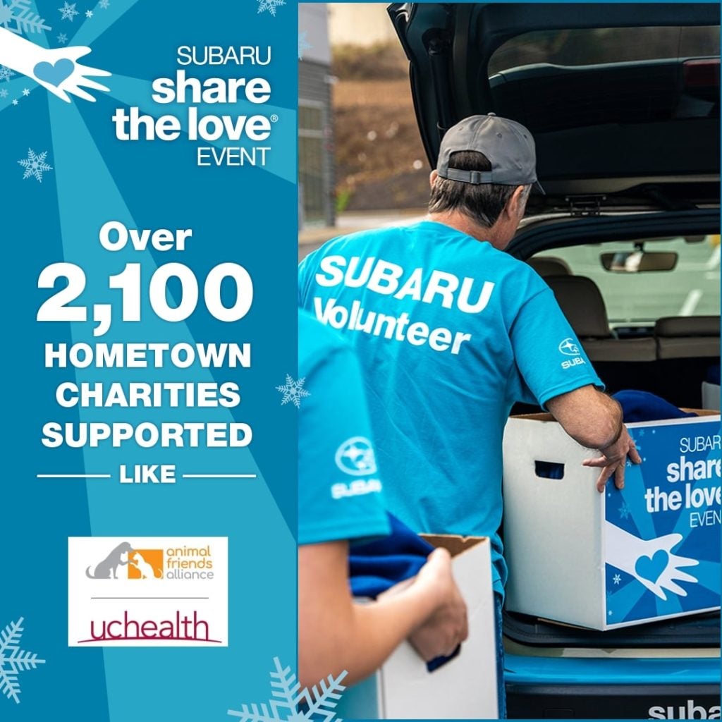 Subaru volunteers loading donation boxes into a vehicle