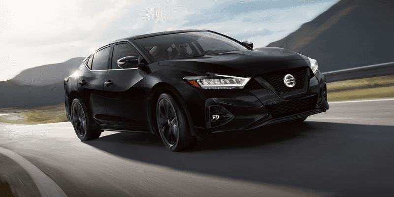 2022 Black Nissan Maxima Driving Swiftly Through the Countryside with Sport Tuned Suspension