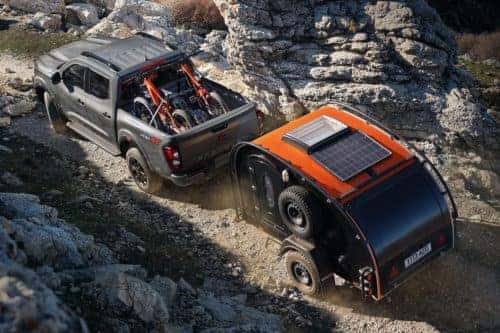 Silver 2021 Nissan Frontier Towing a Camper