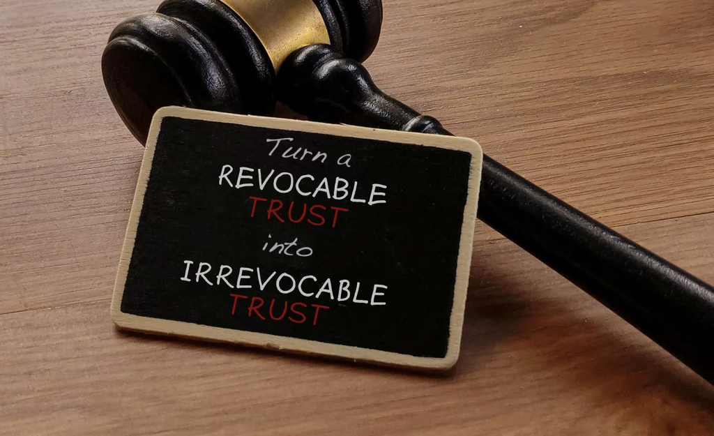 turning a revocable trust into an irrevocable trust written on a chalkboard in front of a gavel
