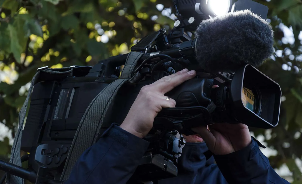 cameraman pointing a television camera in the outdoors Prince Harry Meghan Markle Oprah Interview Breakdown
