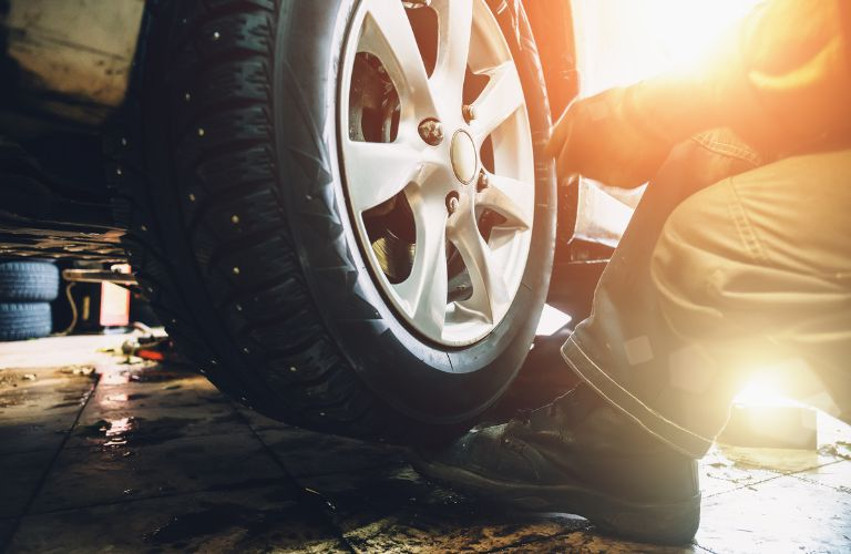 technician inspecting a tire